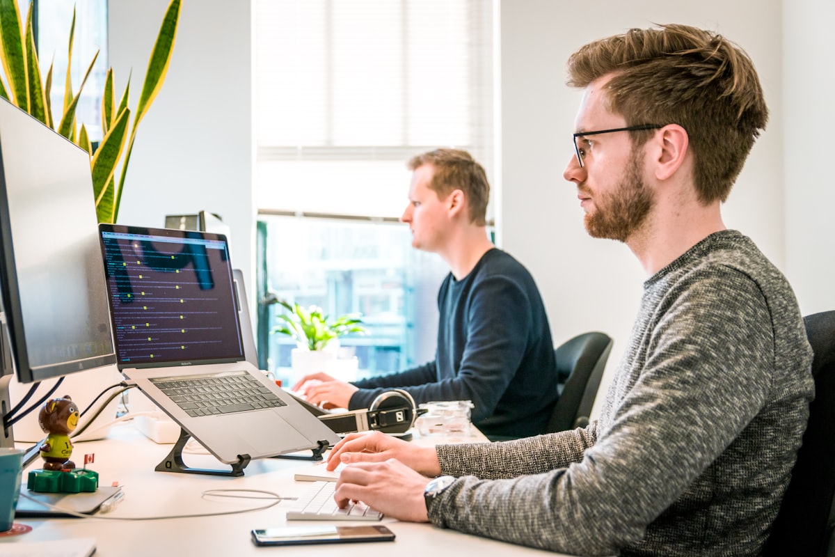 Team of professionals working on laptops in a modern office